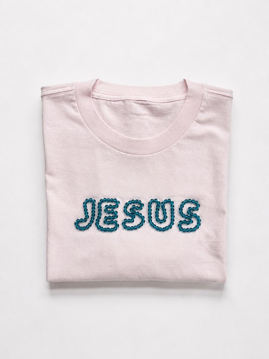 Folded oversized Lilac t-shirt with hand-beaded aqua blue JESUS lettering