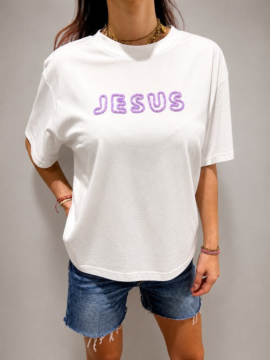 Close-up of oversized White JESUS t-shirt with hand-beaded lilac lettering