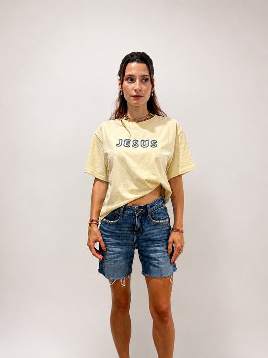 Woman wearing oversized Butter Yellow hand-beaded JESUS t-shirt, Christian and Orthodox tee, front view