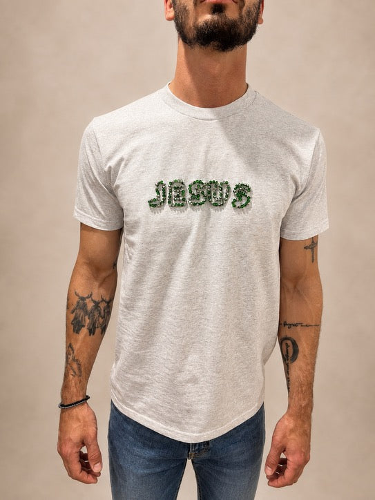 Close-up of Light Grey JESUS t-shirt with hand-beaded green and silver lettering