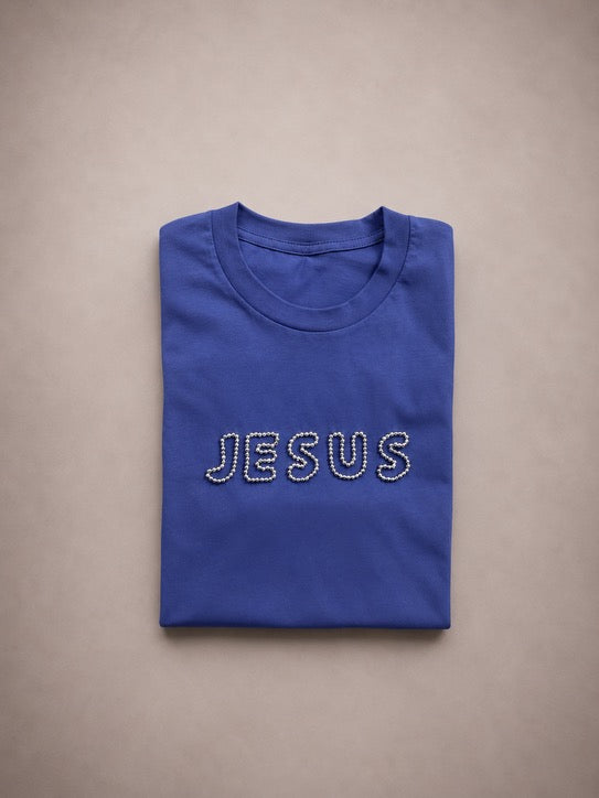Folded Greek Blue t-shirt with hand-beaded JESUS lettering