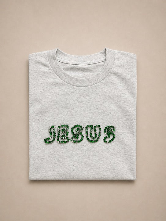 Folded Light Grey t-shirt with hand-beaded JESUS lettering