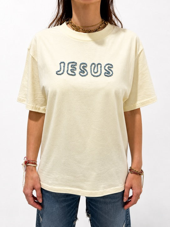 Close-up of oversized Butter Yellow JESUS t-shirt with hand-beaded sky blue lettering