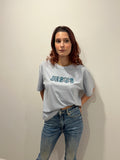 Woman wearing oversized Powder Blue hand-beaded JESUS t-shirt, Christian and Orthodox tee, front view